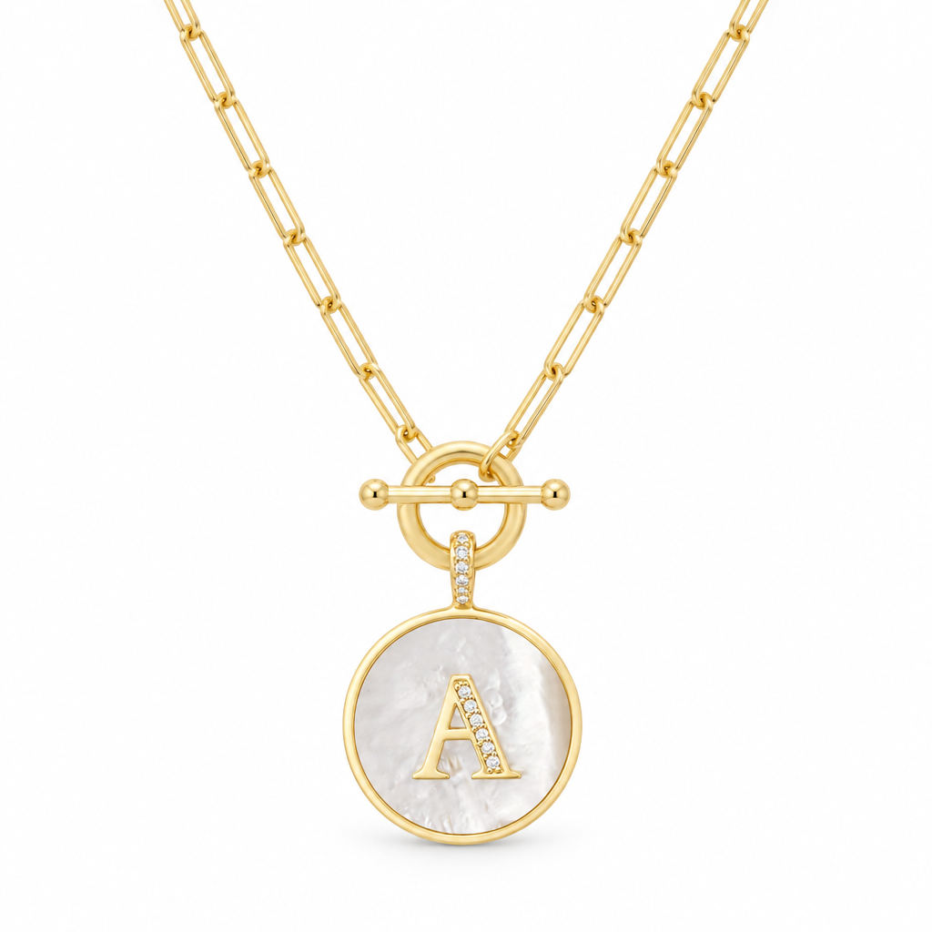 Personalized gold initial A medallion necklace with mother of pearl on a white background